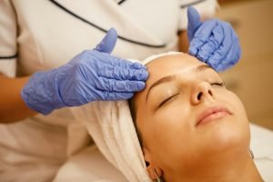 Close-up of woman having head massage at beauty spa.