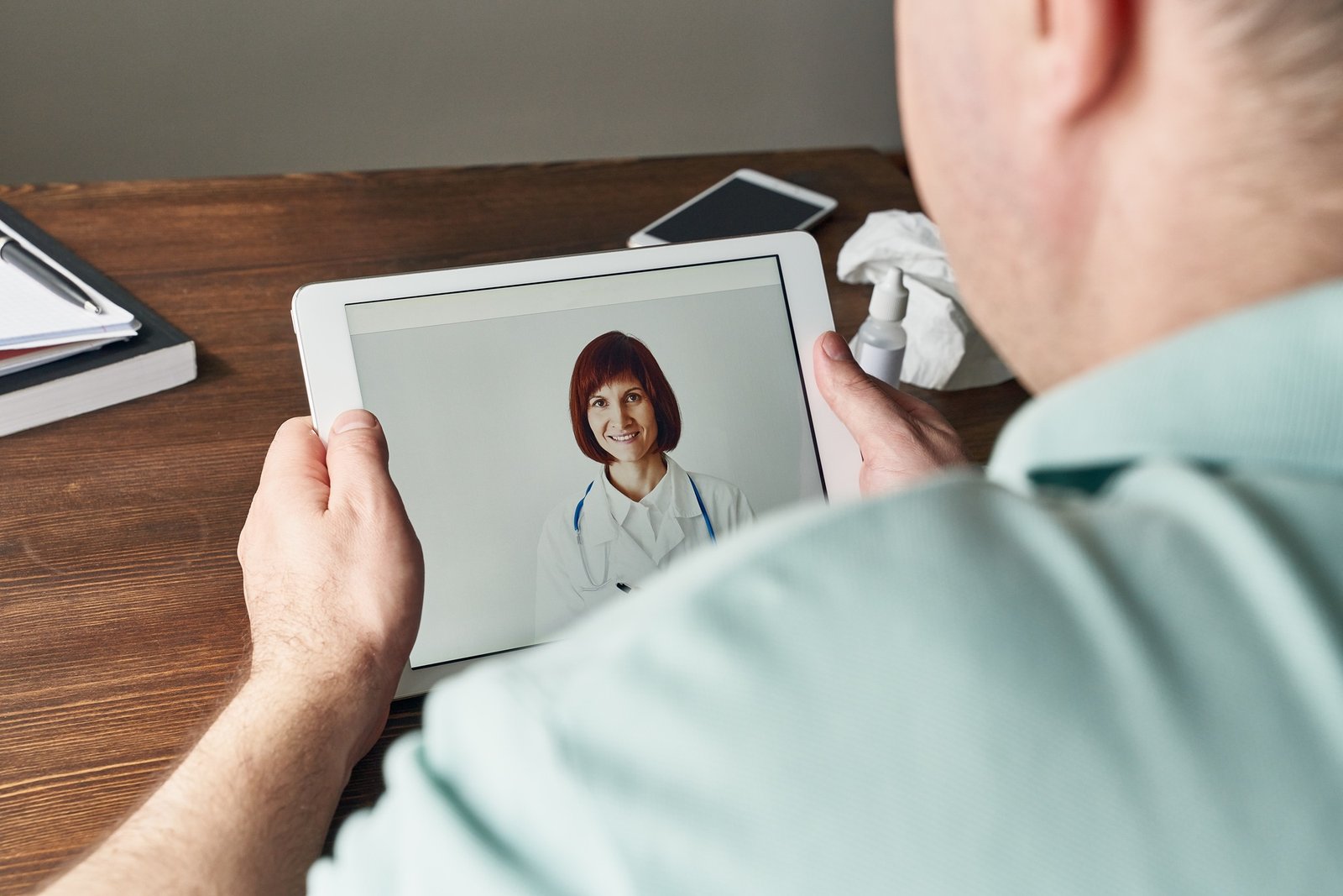 Man looks at tablet, video call to doctor, communication with doctor online. Telemedicine