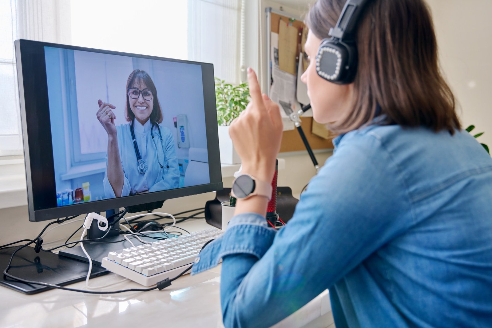 Woman talking to doctor using video call on computer